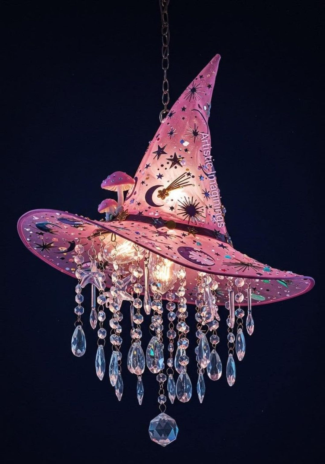 A glowing pink witch-hat chandelier with stars, moons and hanging crystals